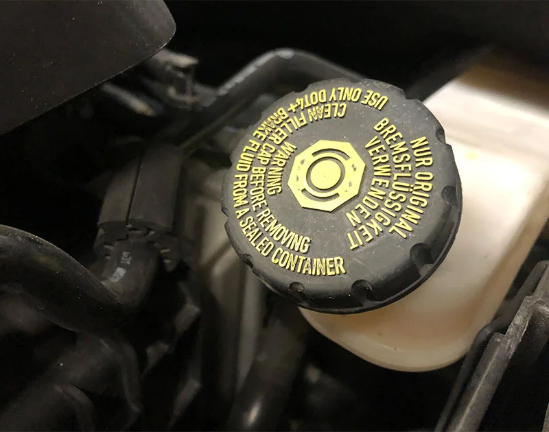 brake fluid fill cap, black with yellow lettering