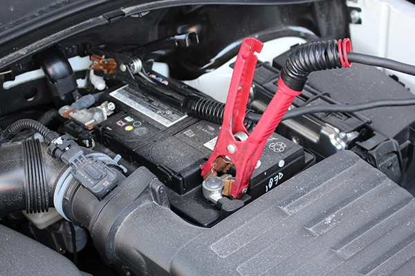 Battery with red jumper cable attached