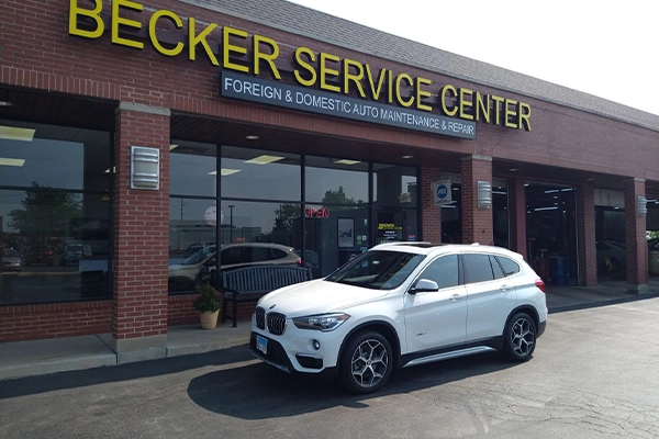 White BMW SUV sitting in front of Becker Service Center