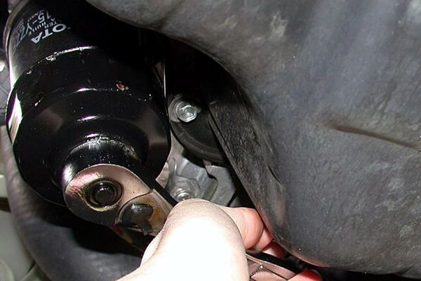 Removing oil filter with a tool