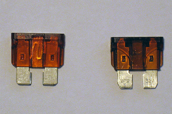 Intact fuse next to a blown fuse