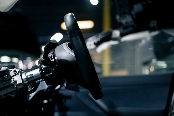 Side view of steering wheel with dash removed showing steering column