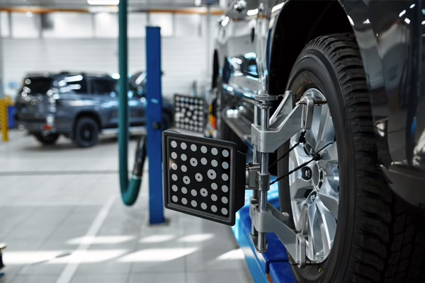 car on wheel alignment rack